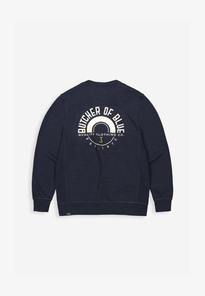 Marineblauer Sweatshirt mit einem runden grafischen Design auf der Rückseite; zeigt den Schriftzug "BUTCHER OF BLUE" und "QUALITY CLOTHING CO." in cremefarbener Schrift.
