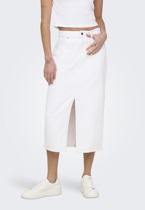 White denim midi skirt with a front slit, featuring a high waist, single button closure, and subtle stitching details. Paired with white sneakers.