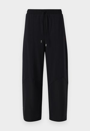 Schwarze Sporthosen mit elastischem Bund und verstellbarem Kordelzug. Mit Detailnähten und einer lockeren, cropped Passform. Glatte Textur.