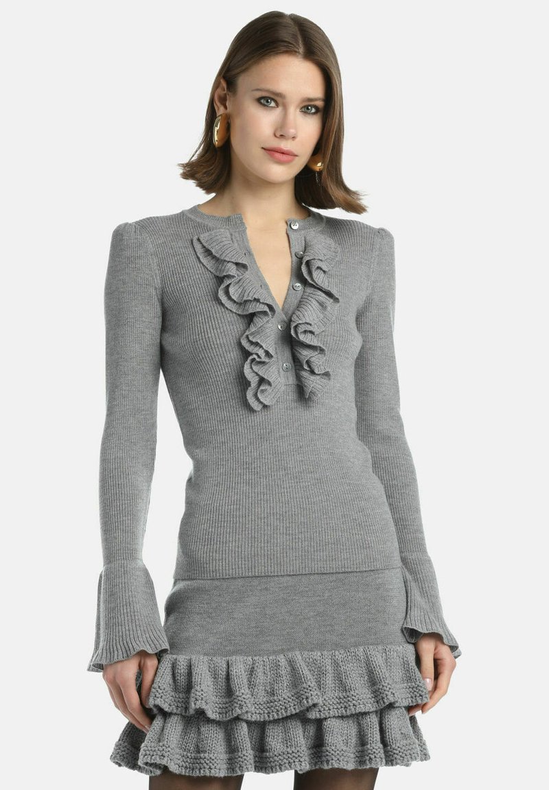Gray ribbed knit sweater-dress with ruffled front placket, long sleeves, and flared cuffs; features a ruffled hemline and button closures.