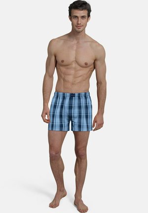 Herren Badehosen im Karodesign mit einer blauen Farbpalette in helleren und dunkleren Tönen, einem elastischen Bund und einem lockeren Schnitt.