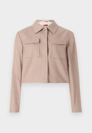 Cropped beige jacket in a fine pinstripe pattern, featuring a collared neckline, two chest pockets, and silver button detail.