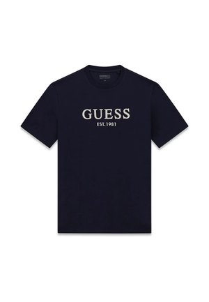 Maglietta nera a maniche corte con girocollo e testo bianco "GUESS EST. 1981" centrato sulla parte anteriore.