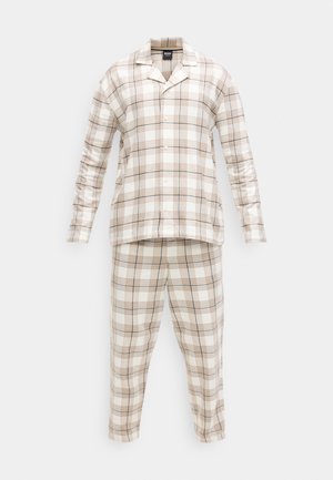 Langermet rutete pysjamas i beige og hvitt, med horisontale og vertikale linjer, knappelukking på overdelen og smale bukser.