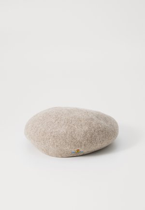 Woolen beret in light beige, round shape with a soft texture. Features a small, colorful embroidered design on the side.