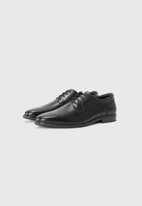 Schwarze Lederhalbschuhe mit einer eleganten, abgerundeten Zehenform, minimalistischem Design, glatter Textur und einfacher Schnürung. Flacher Absatz.