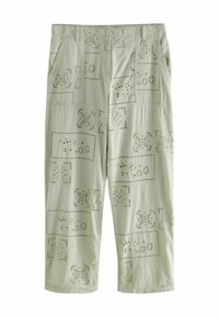 Pantalons vert clair en tissu texturé avec des motifs découpés et des accents rectangulaires. Comprend des poches avant et une coupe décontractée.