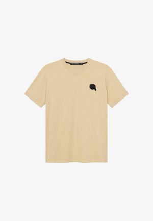 T-shirt beige a maniche corte con scollo a V, logo nero ricamato sul lato sinistro del petto, taglia media secondo l'etichetta del marchio.