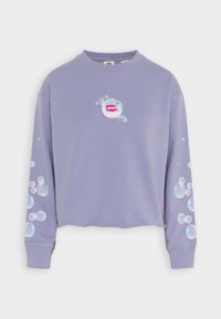 Sweatshirt court à manches longues lavande avec des motifs en forme de bulles sur les manches et la poitrine, arborant le logo Levi's en bulles blanches et roses.