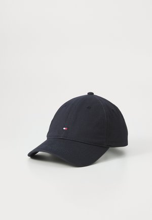Navy baseball cap made of cotton with a curved brim. Features a small red, white, and blue logo on the front. Smooth texture.