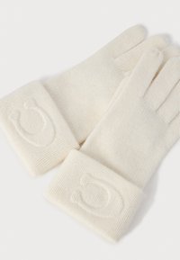 Guantes de color crema hechos de un suave tejido de punto, con un puño acanalado que presenta un diseño de herradura en relieve.