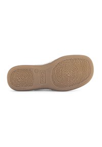 Brown rubber shoe sole with textured patterns and embossed logo. Smooth edges and a circular imprint detail. Size indicator "37" included.