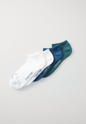 Four pairs of ankle socks in white, dark blue, teal, and green. Each features a logo on the side, made from a soft cotton blend.