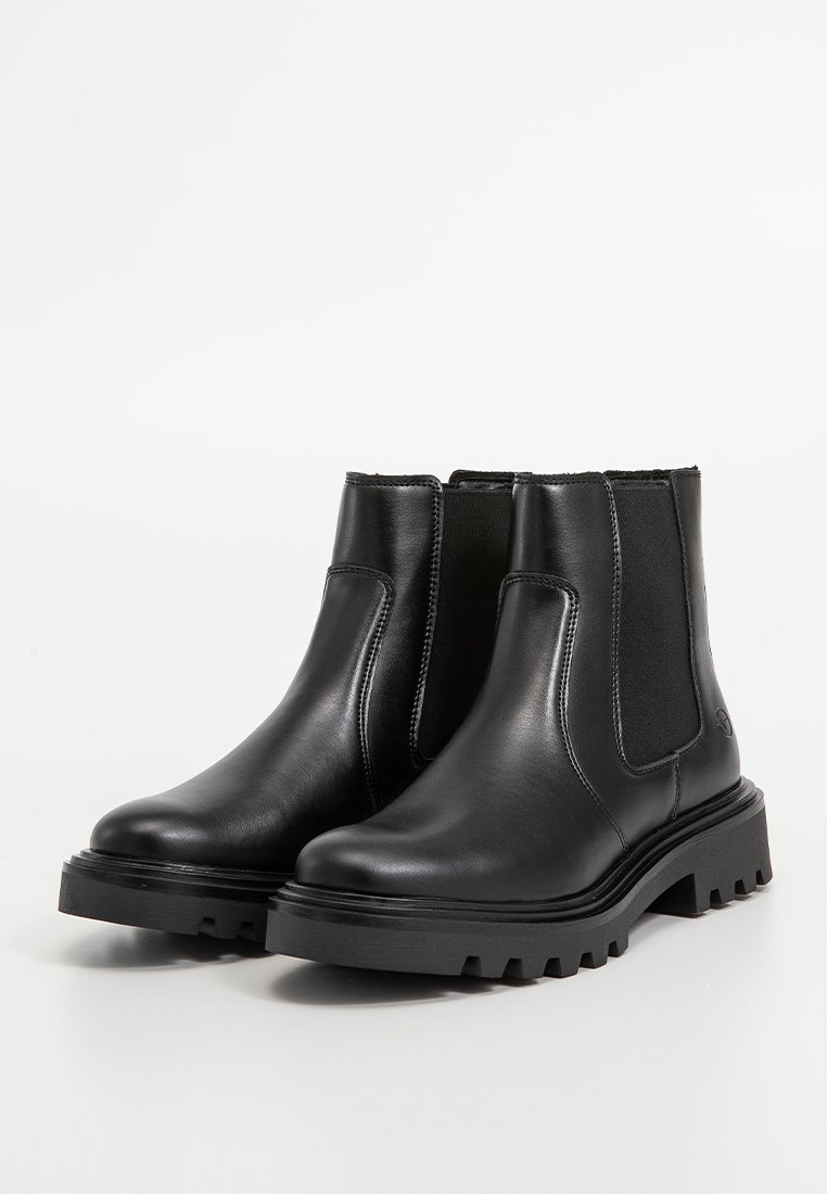 Zwarte leren enkellaarsjes met elastische zijpanelen, een stevige rubberen zool en stikselaccenten langs de randen. Gladde textuur.