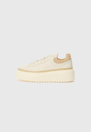 Platform sneakers in cream leather with a textured, ribbed sole, featuring tonal stitching and a beige leather heel accent.