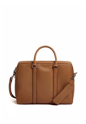 Tan leather bag with a structured design, double top handles, detachable shoulder strap, two front panels, and a zip closure.