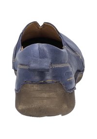 Scarpa slip-on in pelle blu con una texture liscia, punta arrotondata e cuciture sottili lungo le cuciture; suola in gomma visibile nella parte inferiore.