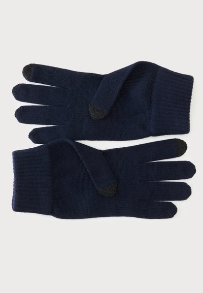 Paire de gants tricotés bleu marine foncé avec embouts noirs compatibles écran tactile sur les pouces et les index, posés à plat sur un fond clair.