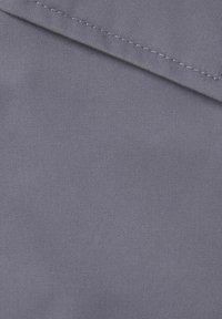 Gray fabric with a smooth texture, featuring a diagonal fold. Fine stitching along the edge adds detail to its minimalist design.