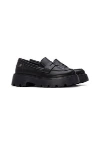 Mocasines de cuero negro de perfil bajo, con una suela de goma gruesa y estriada y una banda en la parte frontal. Textura suave, acentos mínimos.
