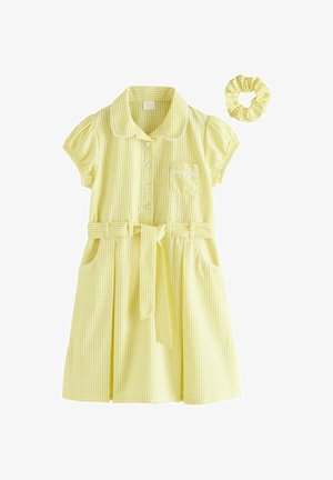 Vestito giallo a maniche corte in tessuto vichy con bottoni a forma di cuore, tasche frontali, cintura in vita e accessorio per capelli scrunchie coordinato.