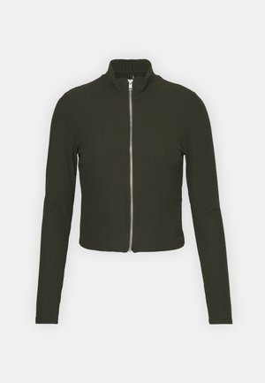 Dark green, ribbed zip-up jacket with a high collar and long sleeves. Tailored fit, cropped length, featuring a silver zipper in front.