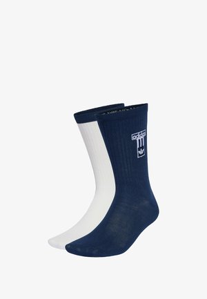 Granatowe i białe skarpetki bawełniane z klasycznym krojem i prążkowaną teksturą. Posiadają logo Adidas i paski. Klasyczny design odpowiedni do noszenia na co dzień.
