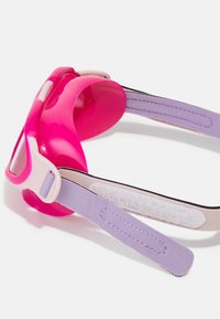 Pink silicone goggles with clear lenses, featuring a lavender adjustable strap and a velcro fastener for secure fitting.
