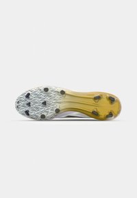 Football cleat with a textured white and yellow outsole, featuring black studs and a subtle graphic pattern. The design is streamlined and modern.