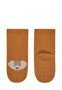 Cotton socks in burnt orange with a dog face design at the toe. Textured rubber grips on the sole enhance traction.