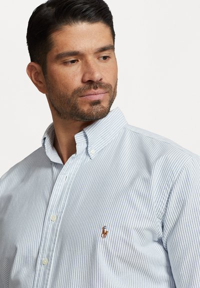 Lyseblå og hvid stribet button-down skjorte lavet af bomuld, med et lille broderet logo på venstre bryst og en klassisk krave.