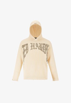 Haut à capuche côtelé couleur crème avec un ourlet effiloché, arborant un design graphique en texte gris foncé sur la poitrine.