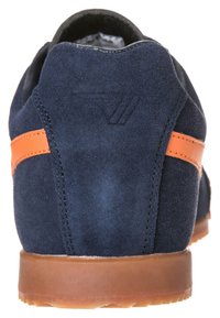 Scarpa scamosciata blu navy con superficie testurizzata e striscia arancione. Design a profilo basso con suola in gomma e logo in rilievo discreto sul tallone.