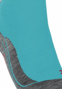 Calza sportiva turchese e grigia con un design testurizzato, impreziosita da accenti rossi. La calza presenta un motivo a coste e una forma sagomata.
