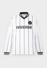 Jersey blanc à manches longues avec des rayures verticales noires, col en V et poignets noirs. Présente un logo circulaire et un texte en gras sur le devant.