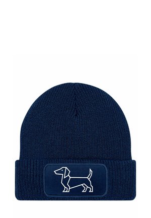 Navy knitted beanie with a folded cuff, featuring a white outline of a dachshund on a rectangular patch. Textured fabric and snug fit.
