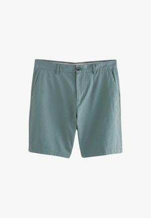 Helles grünes Baumwoll-Shorts mit flacher Vorderseite, Gürtelschlaufen, zwei Seitentaschen und einer einzigen Knopfverschluss. Glatte Textur, lässiges Design.