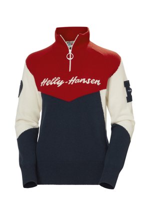 Red, white, and navy knitted sweater with a zip neck. Features "Helly Hansen" in white script and a navy patch on the sleeve.