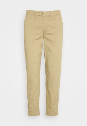 Beige Chinos mit slim fit, aus einem Baumwollmischgewebe. Verfügt über ein klassisches Fünf-Taschen-Design und Gürtelschlaufen. Glatte Textur.