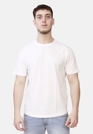 T-shirt in cotone beige chiaro con maniche corte, scollo rotondo e taglio dritto. Presenta un design minimalista e nessun logo visibile.