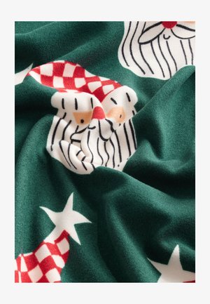 Roheline kangas, millel on mustrina jõuluvana näod, punased ruudulised mütsid ja valged tähed. Pehme tekstuur ja erksad, kontrastsed värvid.