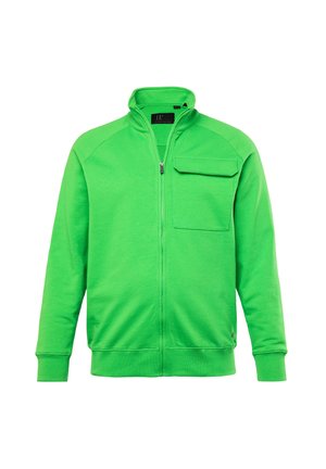 Groene ritstrui gemaakt van zachte stof, met een opstaande kraag en een borstzak met een gestructureerd oppervlak.