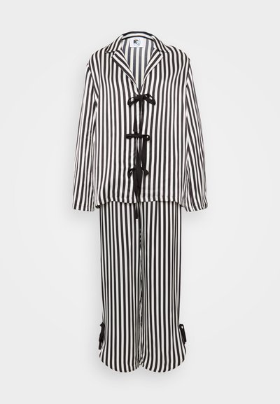 Black and white striped lounge set featuring a button-down top with bow ties and matching wide-leg pants with adjustable cuffs.