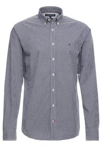 Pánská košile s dlouhým rukávem a knoflíkovou légou v námořnické modro-bílé kostkované vzoru. Má klasický límec a logo na náprsní kapse. Bavlněná směs.