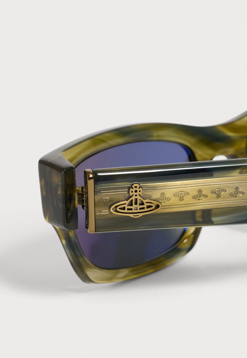 Close-up of green tortoiseshell sunglasses with blue lenses featuring a gold Vivienne Westwood orb logo on the temple arm.