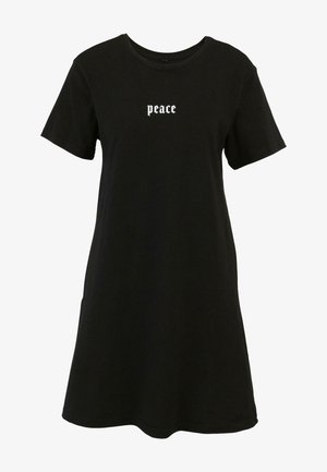 Juoda medvilninė marškinėlių suknelė su trumpomis rankovėmis, laisvu siluetu ir baltais kreivais „taika“ užrašais krūtinėje. Lygus paviršius.