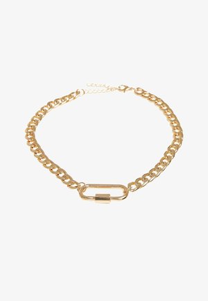 Gold chain necklace featuring large, interlocking links with a central elongated oval clasp. Smooth metallic finish with a shiny texture.