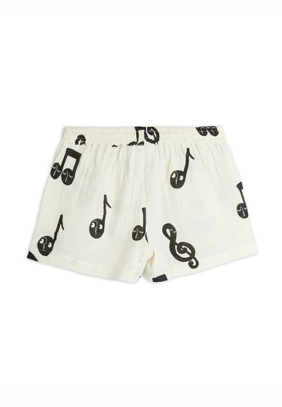 White cotton shorts with black musical notes pattern; features an elastic waistband and loose fit, suitable for casual wear.
