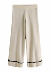 Beežid laia lõikega püksid soonikkoes vöökohaga, millel on must horisontaalne rõhutusjoon ääre lähedal. Pehme kangas, sileda tekstuuriga.