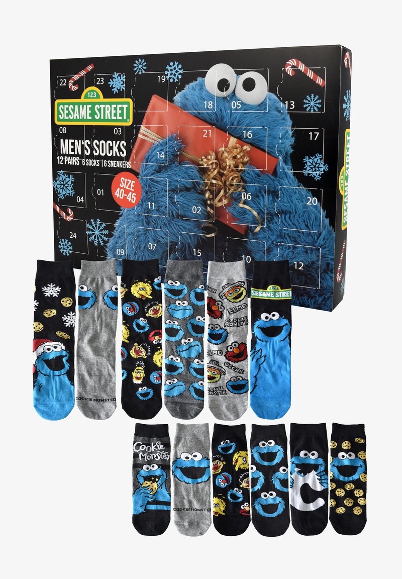 Herren-Socken im Sesamstraße-Thema mit dem Krümelmonster und anderen Charakteren, präsentiert mit einer Adventskalender-Box des Krümelmonsters.